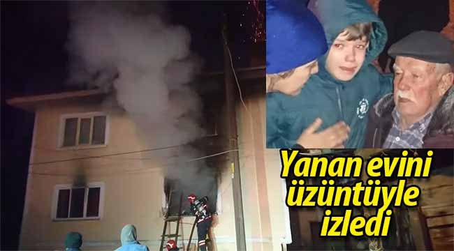 Yanan evini üzüntüyle izledi