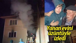 Yanan evini üzüntüyle izledi